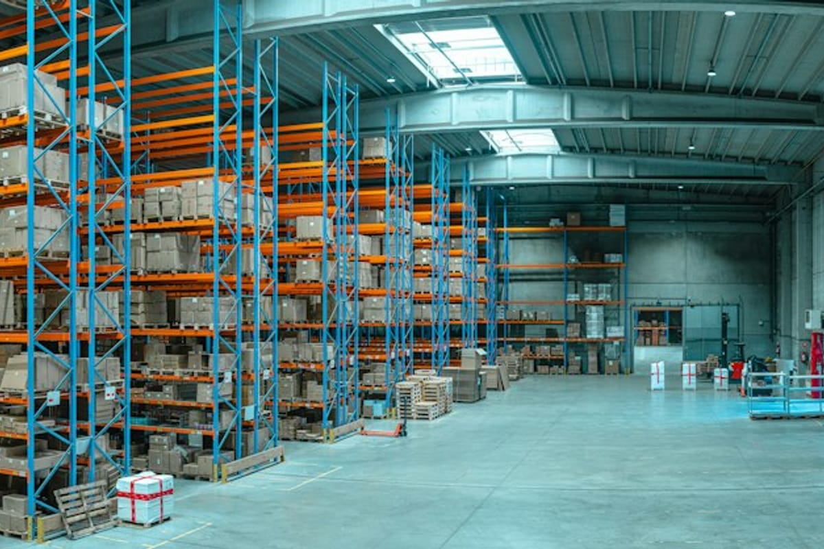 Warehouse aisle with tall blue shelving