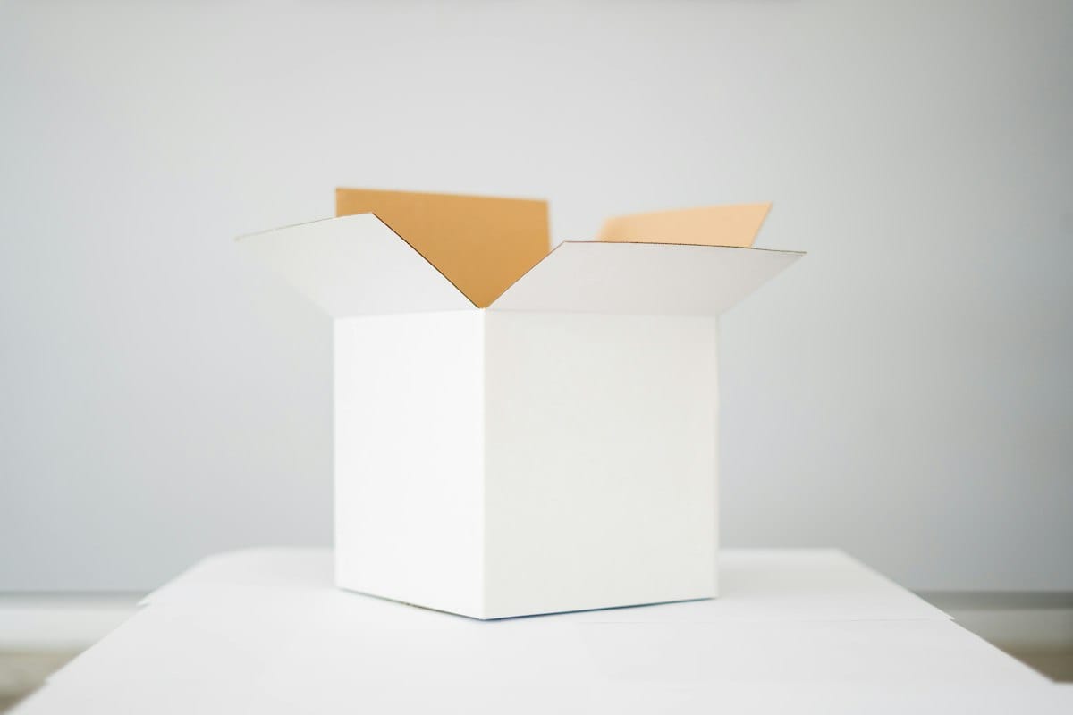 Open white box on a white table