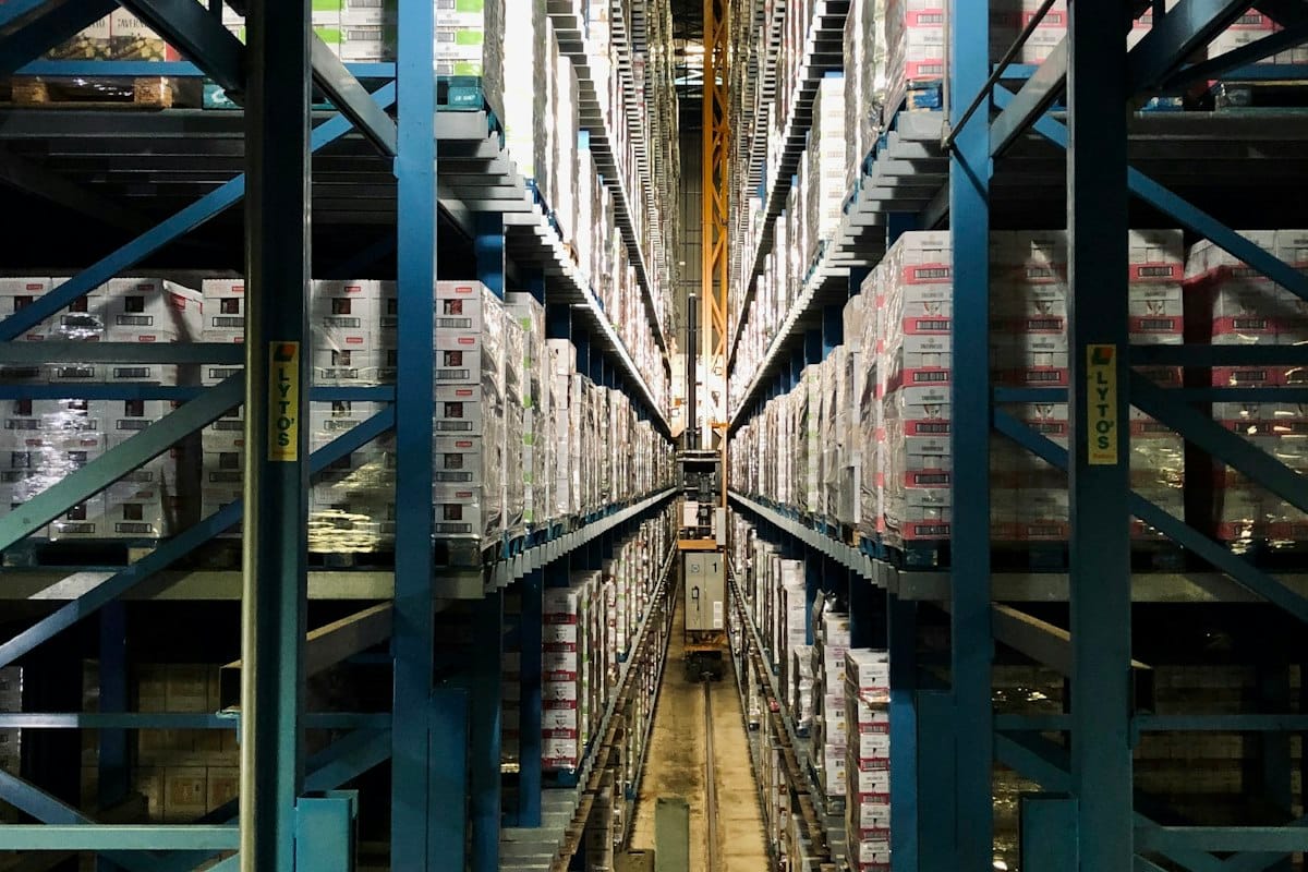 Warehouse aisle with tall blue shelving units